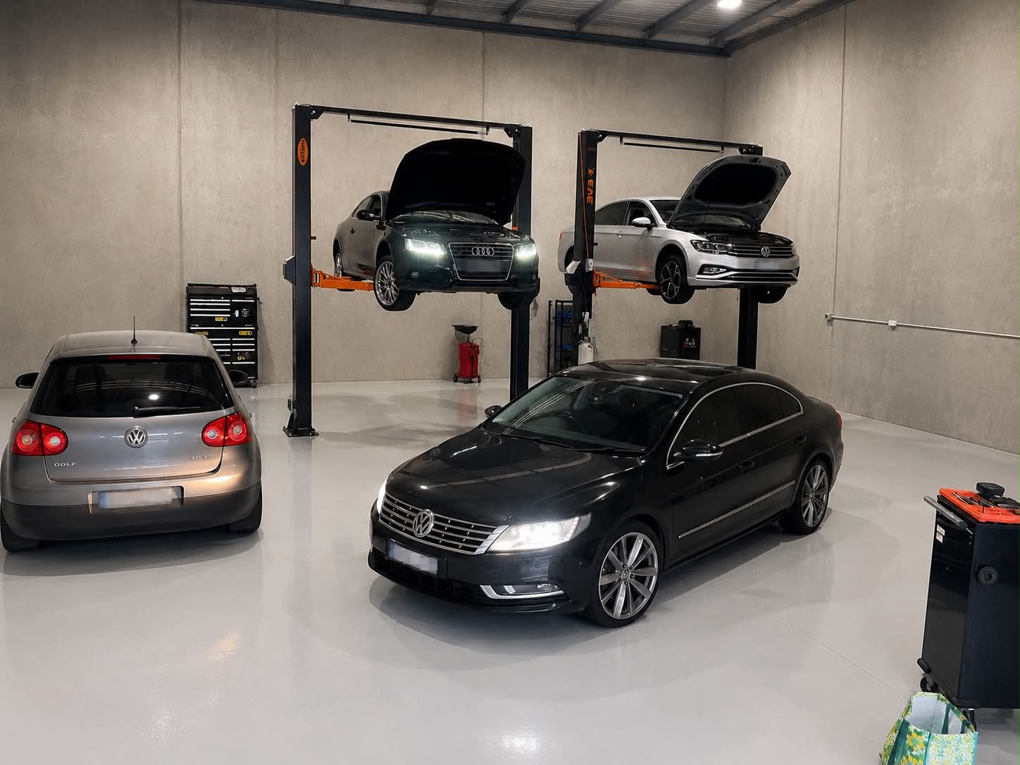 Clean workshop with European vehicles and hoists